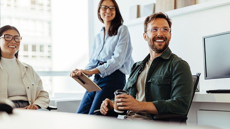 Professionals listening to a discussion in an office.